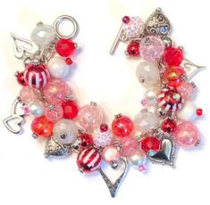 a red and white beaded bracelet with charms