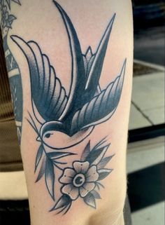 a black and white bird with flowers on it's arm, done by me