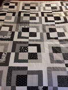 a black and white quilt on a bed