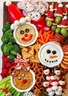 a wooden platter filled with different types of snacks and food on top of each other