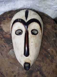 a white mask sitting on top of a wooden table