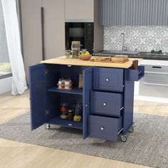 a blue kitchen island with drawers on wheels