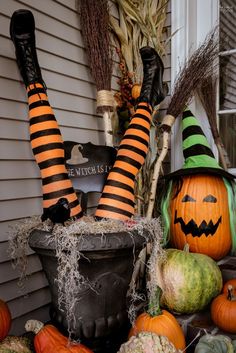 halloween decorations with pumpkins and witch legs