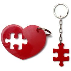 a red heart shaped keychain with a puzzle piece hanging from it's side