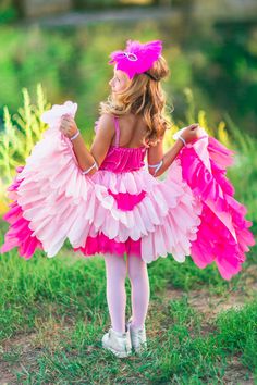 Wings are the perfect addition to her Halloween costume or dress-up play Ultra soft material for comfort & ease Pairs perfectly with our Pink Flamingo Costume "XXS-12-18 Months" fits XXS-S, "Medium-4T" fits M-2XL, "3XL-8/9 Years" fits 3XL-5XL Add the perfect finishing touch to her trick-or-treating look with these Pink Flamingo Wings. These wings feature a ruffled faux feather design with elastic straps at the wrists & shoulders. Pair them with our Pink Flamingo Costume, or add them to her playt Flamingo Fancy Dress, Pink Flamingo Costume, Flamingo Wings, Flamingo Halloween Costume, Pink Halloween Costumes, Sibling Halloween Costumes, Flamingo Outfit, Flamingo Costume, Toddler Girl Halloween