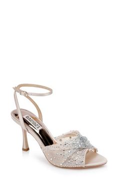 a women's shoe in white satin with sequins on the toe and heel