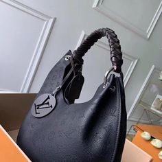 The Carmel hobo bag is a spacious, lightweight style in Mahina calf leather with Monogram perforations. The supple leather and the soft form of the bag combine to make it exceptionally pleasant to carry. Craft details such as the braided handle and LV leather charm add to the sophistication of this model. Detailed Features 35 x 40 x 17 cm (Length x height x width ) Black Mahina perforated calf leather Calf-leather trim Microfiber lining Silver-color hardware Magnetic closure 2 compartments Pocke Sac Louis Vuitton, Beg Tangan, Tas Bahu, Black Louis Vuitton, Tas Fashion, Bags Designer Fashion, Black Leather Bags, Virgil Abloh, Somali