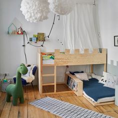 a child's bedroom with bunk beds and toys on the floor, including a toy dinosaur