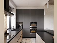 a modern kitchen with black counter tops and wooden cabinets, along with marble flooring