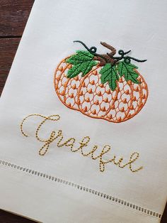 an embroidered piece of cloth with the word grace written in cursive writing on it