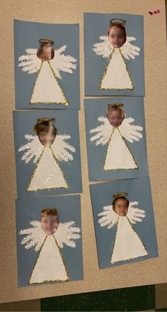 four pictures of an angel with white wings on blue paper and gold glittered edges