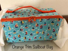 an orange trim sailboat bag is sitting on a chair