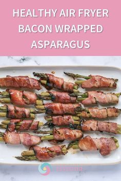 bacon wrapped asparagus on a plate with text overlay that reads healthy air fryer bacon wrapped asparagus