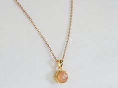 Pretty little golden pendant with a peach moonstone (peach-colored stone) in cabochon. You can buy: - the pendant alone - the pendant plus a 40cm golden chain (choker), 17.7" (1 micron=1 µ) - the pendant plus a 45cm golden chain (standard: princess necklace), 17.7" (1 micron=1 µ) - the pendant plus a 60cm golden chain (necklace), 17.7" (1 micron=1 µ) - the pendant plus a 40cm, 17.7" gold-plated chain (3 microns = 3µ) - the pendant plus a 45cm, 15.5" gold-plated chain (3 microns = 3µ) OTHER INFOR Peach Round Necklace For Gift, Peach Round Necklace Gift, Round Peach Necklace For Gift, Peach Necklace Gift, Gift Round Peach Necklace, Golden Chain Necklace, Golden Pendant, Princess Necklace, Golden Chain