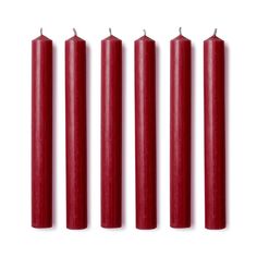 five red candles lined up against a white background