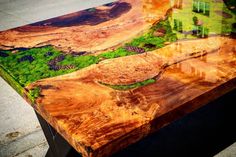 a table made out of wood sitting on top of a sidewalk