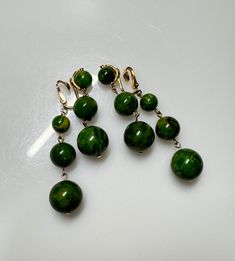 Vintage Green Color Bakelite Napier Earings. Very good condition. Length of earring approximately 70 mm. biggest bead size 15.50 mm. Smallest bead size 9.40 mm. For any question feel free to ask. Vintage Green Earrings With Dangling Beads, Vintage Green Beaded Earrings With Round Beads, Vintage Green Beaded Earrings, Elegant Round Earrings With Large Beads, Green Polished Bead Earrings, Green Earrings With Polished Round Beads, Green Color, Green Colors, Favorite Jewelry