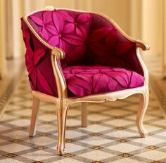 a pink chair sitting on top of a checkered floor