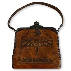 "Antique hand-tooled leather Bosca Nelson Edwardian handbag. made circa 1920s. Bosca was an Italian American immigrant whose handbags are of the highest workmanship and quality. Art Deco styling with butterfly and flowers. Clasp is in good working condition and interior is clean. Maker's tag inside. 10\" bottom to top; 6\" Wide." Vintage Embossed Satchel For Everyday Use, Vintage Embossed Leather Shoulder Bag, Vintage Leather Embossed Shoulder Bag, Vintage Embossed Satchel Bag, Vintage Leather Shoulder Bag With Embossed Details, Antique Engraved Rectangular Bags, Antique Engraved Rectangular Bag, Antique Rectangular Engraved Bags, Vintage Hand Tooled Satchel For Daily Use