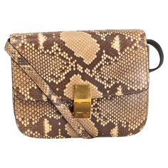 100% authentic Céline Classic Shoulder Bag in vanilla, beige, taupe and brown python leather. Opens with a gold-tone metal push-lock and is lined in black smooth lambskin. Interior is divided in two compartments with one zipper pocket against the back and two open pockets against the front. Comes with an adjustable shoulder strap. Has been carried and is in excellent condition. Comes with dust bag. Measurements Height 20cm (7.8in) Width 24cm (9.4in) Depth 8cm (3.1in) Shoulder Strap Length 94cm (36.7in) Hardware Gold-Tone All our listings include only the listed item unless otherwise specified in the description above. Celine Classic Box Bag, Celine Classic Box, Structured Shoulder, Burberry Classic, Fendi Peekaboo, Bottega Veneta Shoulder Bag, Celine Bag, Designer Shoulder Bags, Small Shoulder Bag