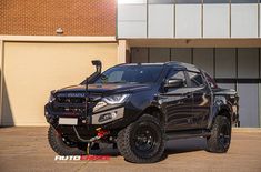 a black truck parked in front of a building