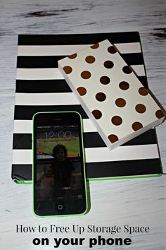 a cell phone sitting on top of a table next to a box with polka dots