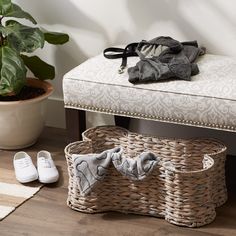 a pair of slippers sitting on top of a wooden floor next to a basket