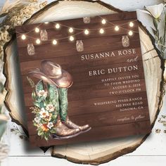 this is an image of a wedding card with cowboy boots and flowers on the front