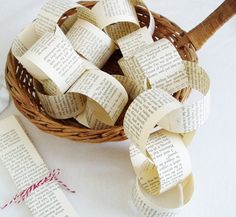 a basket filled with lots of books sitting on top of a table next to a ribbon