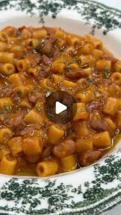 a bowl filled with pasta and sauce on top of a table