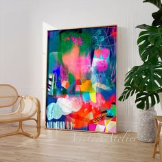 an abstract painting is displayed on the wall next to a chair and potted plant