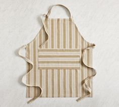 a striped apron hanging on the wall with a white and brown stripe pattern around it