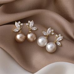 Pearls and butterflies are symbols of transformation, sophistication, and beauty. Instantly elevate any outfit with these beautifully crafted earrings. Copper plated Cubic zirconia crystals, imitation pearl Size: 1.2in x 0.6in Lightweight Pushback stud closure Hypoallergenic, lead & nickel free If you aren't in LOVE with your purchase, please let us know within 30 days of receiving your item, and you'll receive a stress-free refund. Crystal Pearl Earrings As A Gift, Elegant Crystal Pearl Earrings As Gift, Elegant Crystal Pearl Earrings For Gift, Evening Pearl Earrings With Cubic Zirconia, Elegant Crystal Clip-on Earrings, Elegant Crystal Pearl Earrings For Pierced Ears, Elegant Crystal Pearl Earrings, Pearl Pendant Earrings, Inexpensive Jewelry