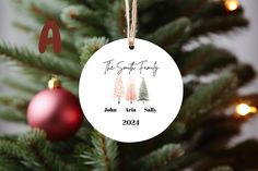 a personalized ornament hanging from a christmas tree