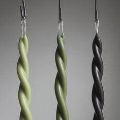 three green and black pendants hanging from hooks