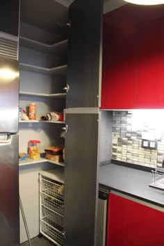 a kitchen with stainless steel appliances and red cabinets