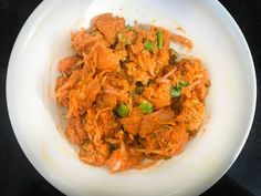 a white bowl filled with food on top of a table