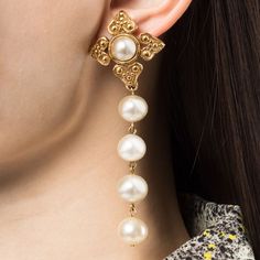 Pearls have the power to fix everything and we think these 1980s clip-on earrings do just that. Featuring a string of pearls hanging from a gold-toned pendant inspired by a Chanel signature, the maltese cross. These timeless earrings have been finished with a central pearl for maximum impact. Wear them on their own, or incorporate them into a stack for an elegant finish.Condition: Very good vintage condition. Minor signs are visible on the faux pearls. Timeless Earrings, Women's Circle, Costume Earrings, Maltese Cross, String Of Pearls, Chanel Earrings, Balenciaga Designer, Gold Earrings Dangle, Single Earring