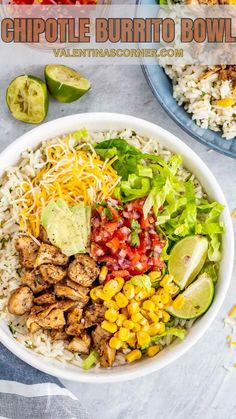 a white bowl filled with chicken, rice and veggie burrito bowls on top of a table