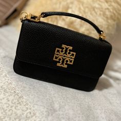 Tory Burch Black Elegant Black Flap Bag For On-the-go, Tan Bag With Gold-tone Hardware For On-the-go, Tan Crossbody Shoulder Bag With Gold-tone Hardware, Tan Crossbody Flap Bag With Gold-tone Hardware, Tan Evening Crossbody Flap Bag, Evening Tan Crossbody Flap Bag, Tan Crossbody Flap Bag For Evening, Tan Crossbody Shoulder Bag For Evening, Tan Crossbody Bag With Gold-tone Hardware