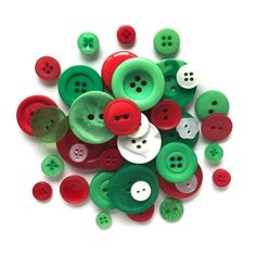 a pile of green and red buttons sitting on top of each other