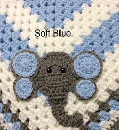 an elephant crocheted on top of a blue and white blanket that says soft blue