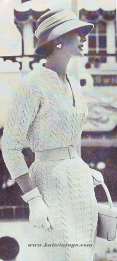 an old photo of a woman in a dress and hat