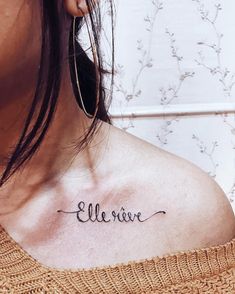 a woman with a small tattoo on her upper arm and chest that says,'believe '