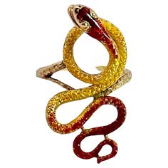 This lovely snake ring comes out of a lady's estate which she purchased in Florence in 1961. This ring is all enamel in shades of gold, yellow, orange and some brown. There is some enamel loss but little and it does not deflect from this lovely ring. The gold is 18K Yellow Gold and the snake takes on many curves. The body of this snake is etched like snakeskin and the body is thin and curving. This is a size 5 1/4 to 5 1/2 it is 1 3/4" long and 1/2" wide. This weighs in at 7.32 grams. This snake is very feminine with its curling and curving shape. Do not miss this as I do not think it will last long. Victorian Pendant Necklace, Victorian Pendants, Vintage Cocktail Ring, Cocktail Jewelry, Snake Pendant, Snake Bracelet, Snake Ring, Shades Of Gold, The Snake