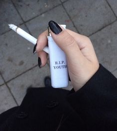 a person holding a white and black pen with the words rip youth written on it