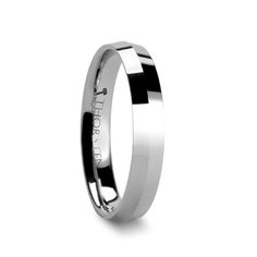 a white gold wedding ring with an inscription engraved on the side and black inlays