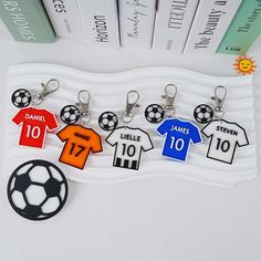 soccer jersey keychain with name and number on each side, hanging in front of bookshelf