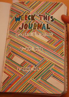 a person holding up a book with the words webk this journal written on it