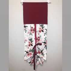 a red and white curtain hanging on the side of a wall